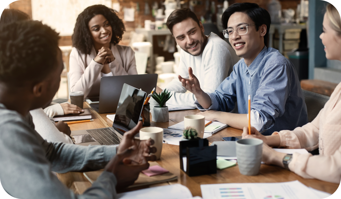different ethnic employees talking around a table